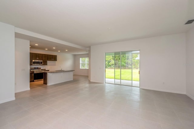 unfurnished living room featuring sink