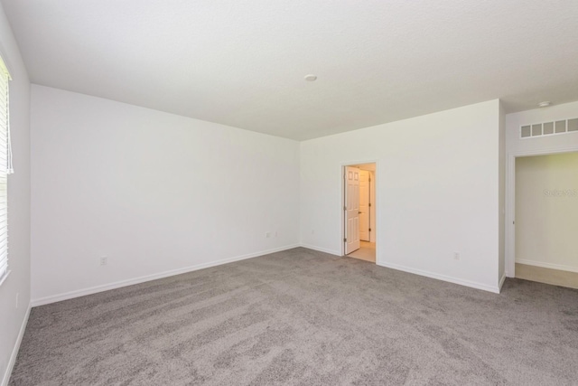 unfurnished room with light carpet