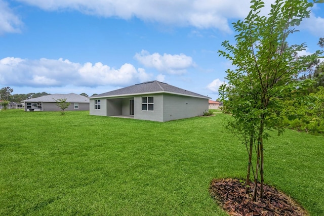 rear view of property with a lawn