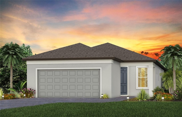 view of front of property with a yard and a garage