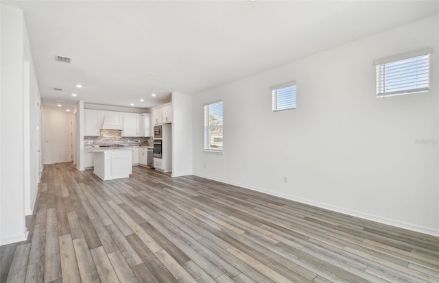 unfurnished living room featuring light wood-type flooring