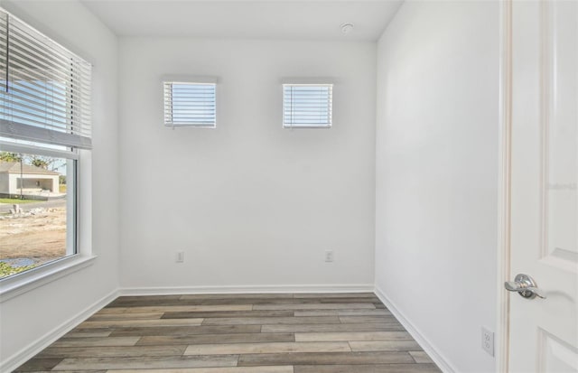 spare room with hardwood / wood-style flooring and a wealth of natural light