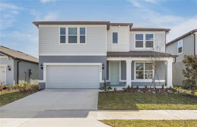 front facade featuring a garage and a front lawn