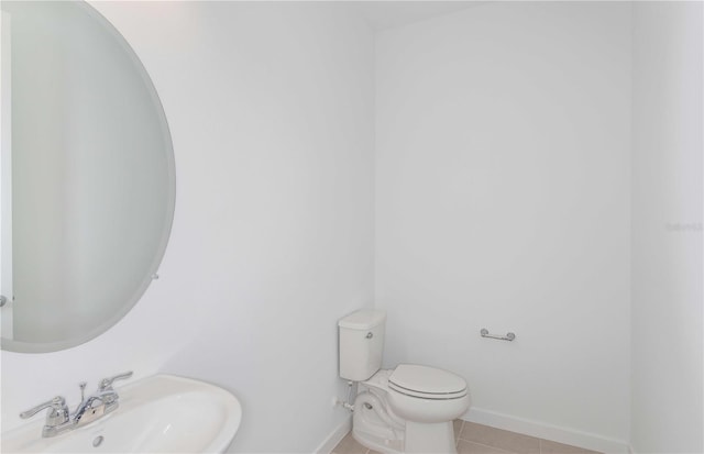 bathroom featuring sink, tile patterned floors, and toilet