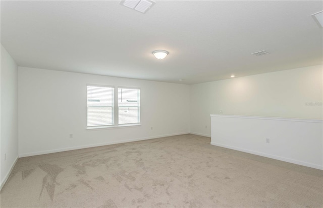 unfurnished room with light carpet