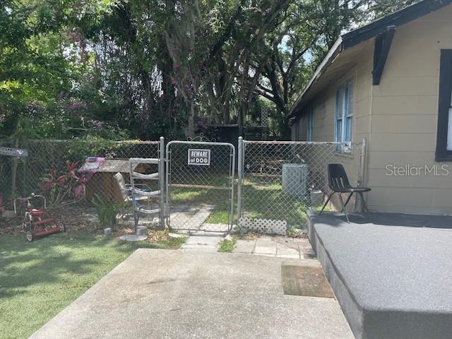 view of gate with a lawn