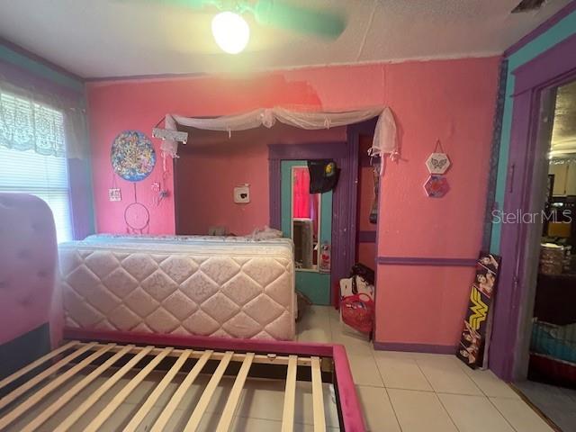 bedroom featuring ceiling fan and light tile patterned floors