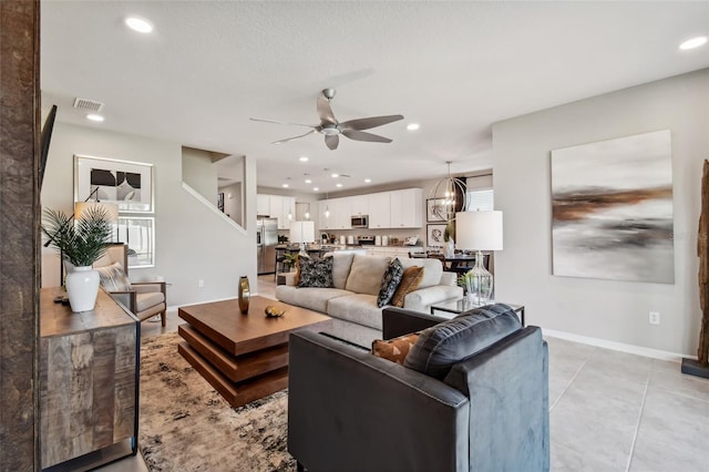 living room featuring ceiling fan and light tile patterned flooring