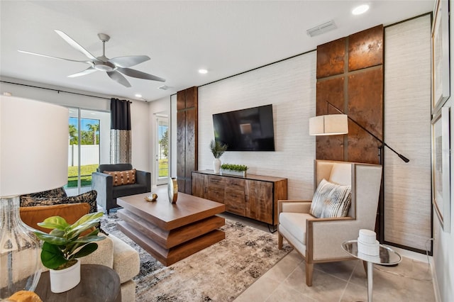 living room with ceiling fan and light tile patterned flooring