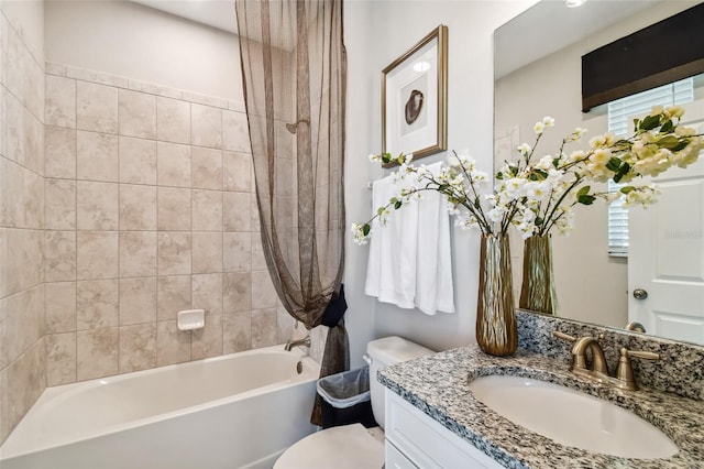 full bathroom with tiled shower / bath combo, toilet, and vanity