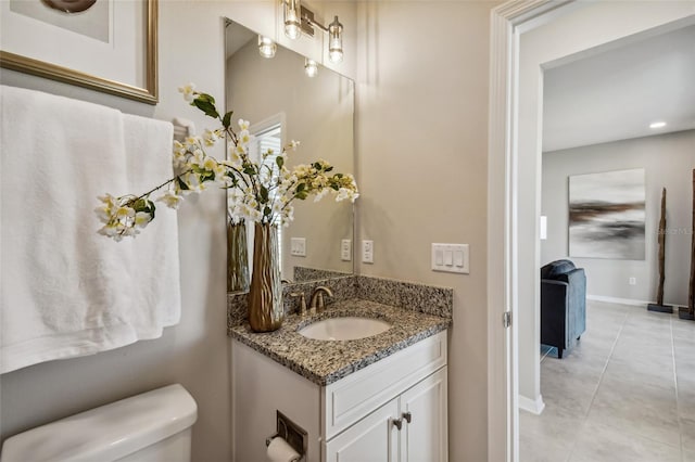 bathroom featuring tile patterned floors, vanity, and toilet