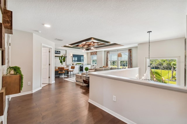 hallway featuring a textured ceiling and dark hardwood / wood-style floors