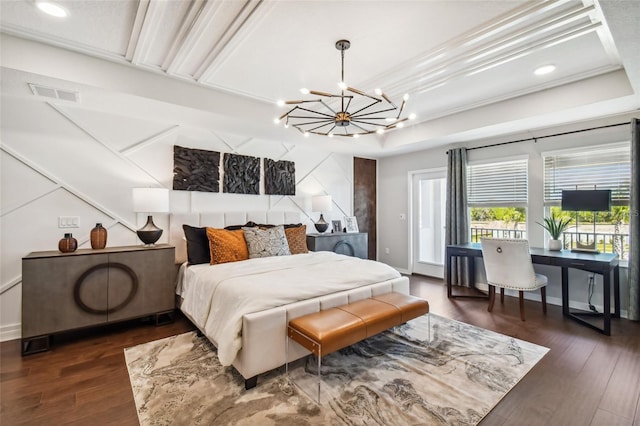 bedroom featuring a raised ceiling, dark hardwood / wood-style flooring, ornamental molding, and an inviting chandelier