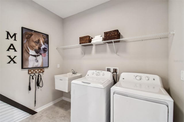 washroom with separate washer and dryer and sink