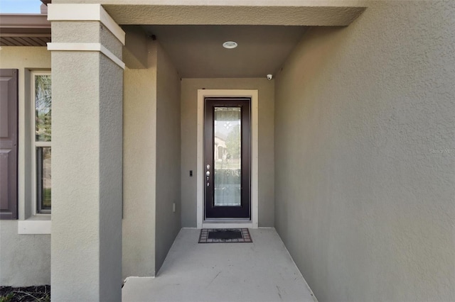 doorway to property with stucco siding