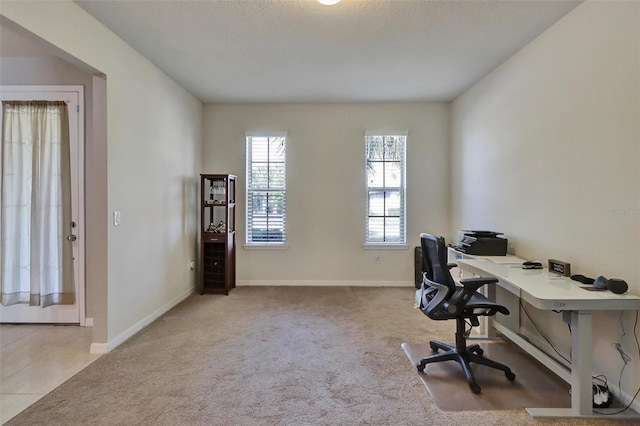 carpeted office space with a textured ceiling