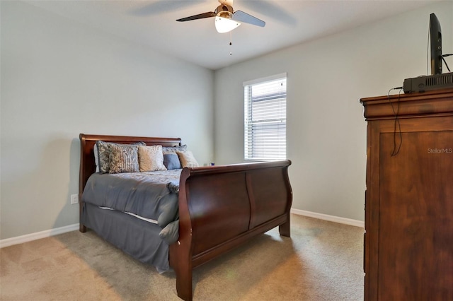 bedroom with ceiling fan and light colored carpet