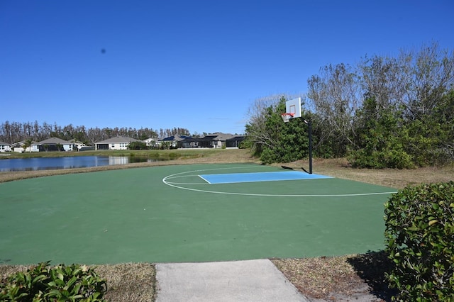 view of basketball court featuring community basketball court, a water view, and a residential view