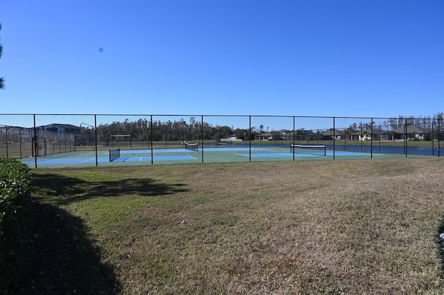 view of sport court featuring a lawn and fence