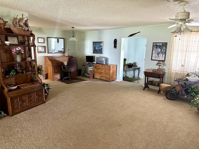 office space with carpet floors, a textured ceiling, and a ceiling fan