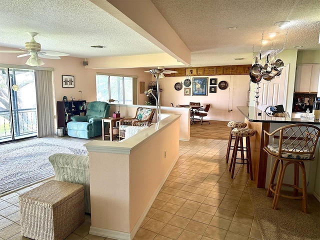 kitchen featuring light tile patterned floors, plenty of natural light, and a ceiling fan