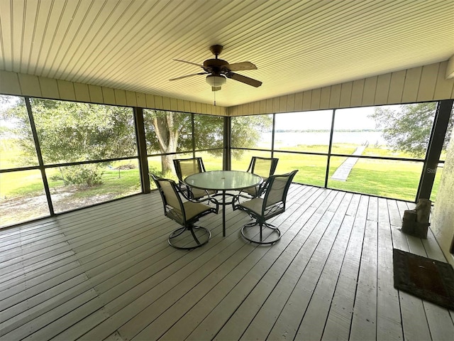 unfurnished sunroom with ceiling fan