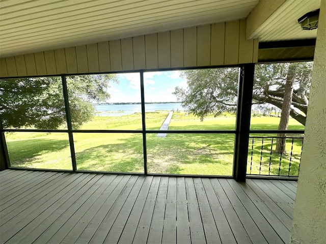 unfurnished sunroom featuring lofted ceiling and a water view