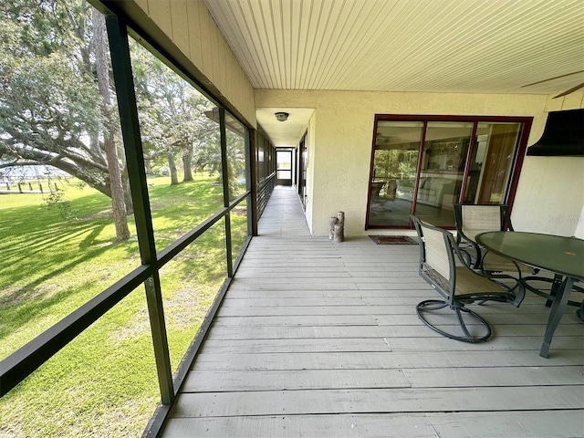 wooden deck featuring a lawn