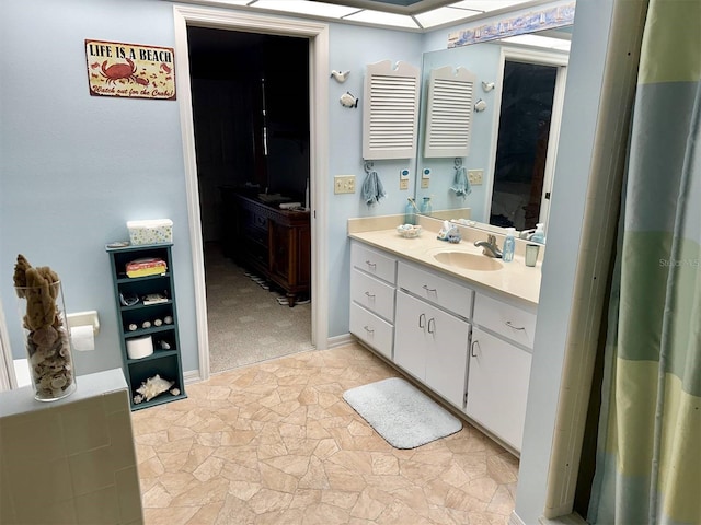 bathroom with stone finish floor and vanity