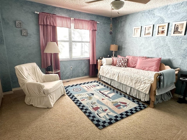 carpeted bedroom featuring ceiling fan and a textured ceiling