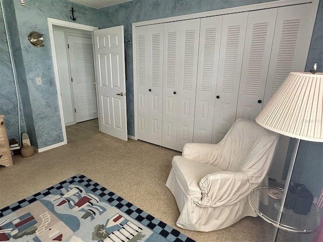 sitting room with carpet flooring and baseboards