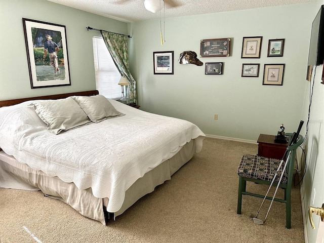 bedroom featuring a textured ceiling, carpet, and baseboards