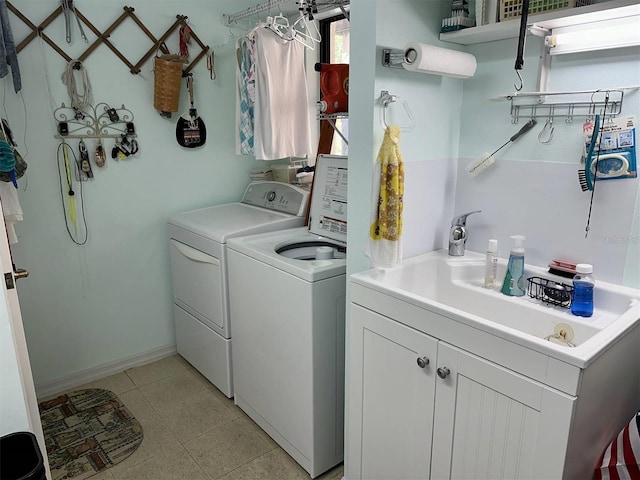 laundry room with separate washer and dryer, cabinet space, and baseboards