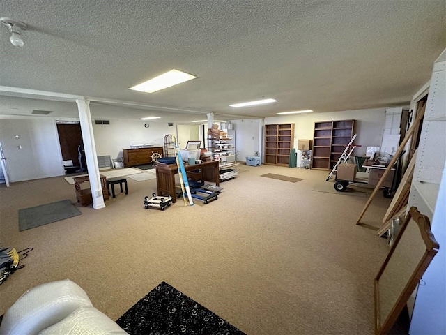 misc room with ornate columns, visible vents, a textured ceiling, and carpet flooring