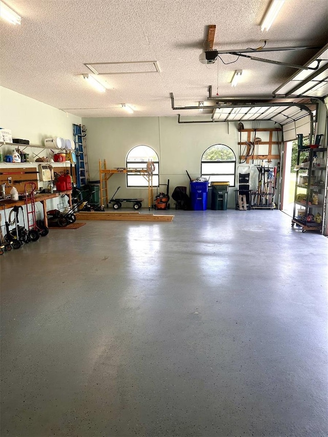 garage with a workshop area and a garage door opener