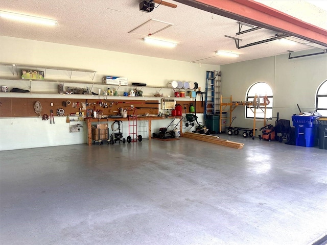 garage with a workshop area and a garage door opener