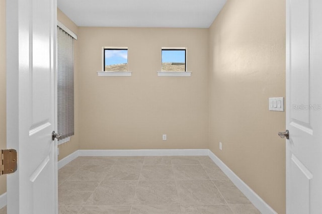 unfurnished room featuring light tile patterned floors