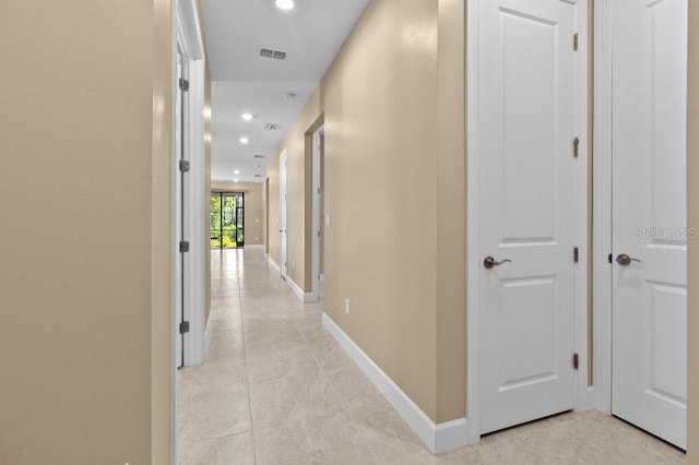 hall with light tile patterned floors