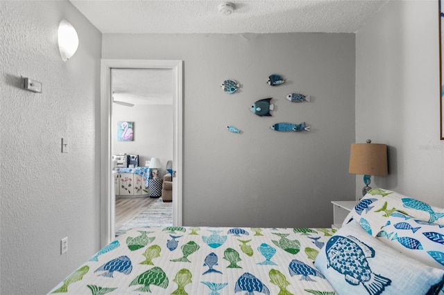 bedroom with hardwood / wood-style flooring and a textured ceiling