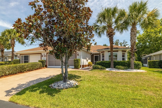 view of front of house with a front yard and a garage