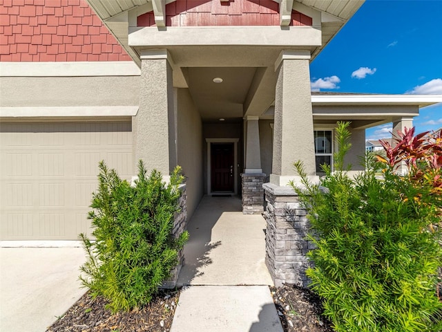 doorway to property with a garage