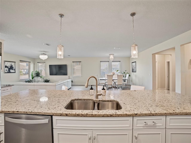 kitchen with sink, white cabinetry, dishwasher, and light stone countertops