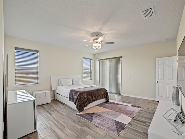 bedroom featuring a textured ceiling and ceiling fan