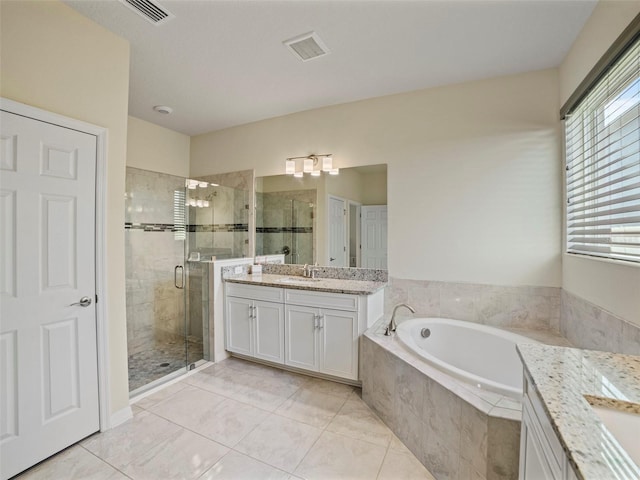 bathroom featuring plus walk in shower, tile patterned floors, and vanity