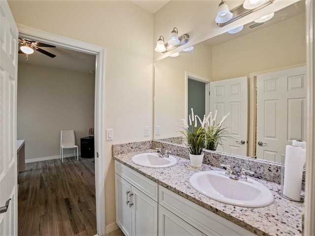 bathroom with ceiling fan, vanity, and hardwood / wood-style flooring