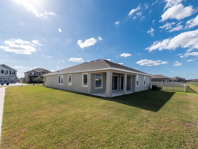 rear view of house with a yard and a patio area