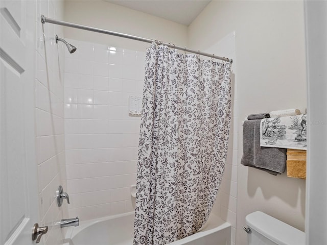 bathroom with toilet and shower / bath combo