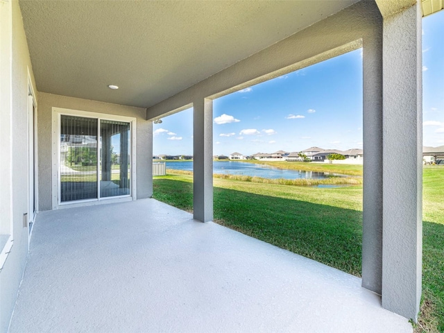 view of patio with a residential view and a water view