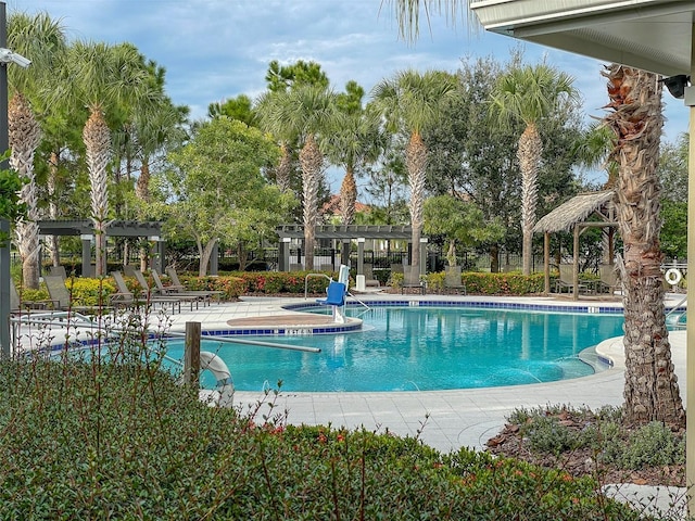 pool with a patio, fence, and a pergola