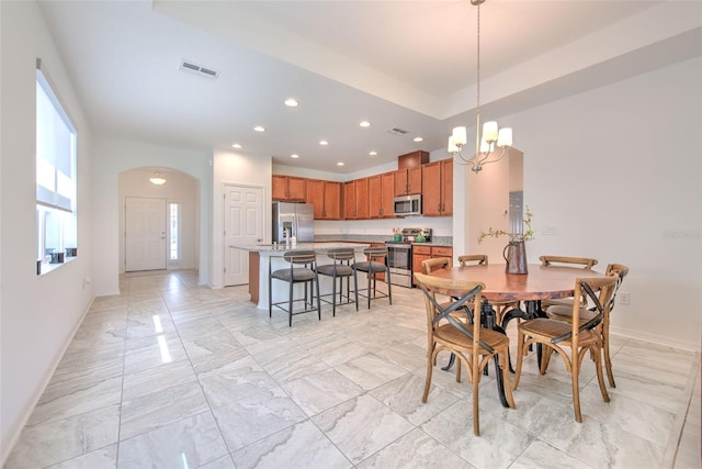 dining space with an inviting chandelier